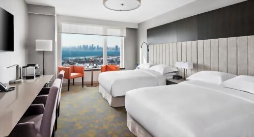 The Library Club Guestrooms with 2 Queen Beds rooms are located on the upper floors, with spectacular City views, accentuated by over-sized windows.