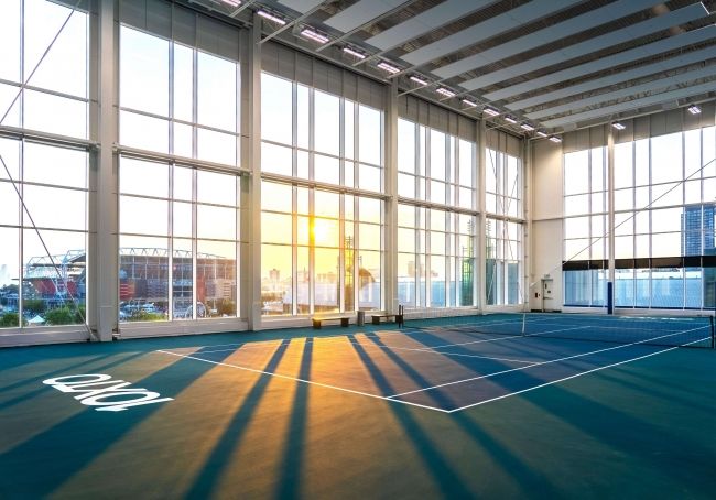 Four Indoor DecoTurf Tennis Courts with an Australian Open two-tone blue color scheme with ceiling to floor windows offering views of the lake and surrounding city while you play your game.