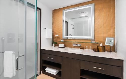 The bathroom offers the luxury of spacious granite counter and a glass encased, stand alone, high-pressure shower.